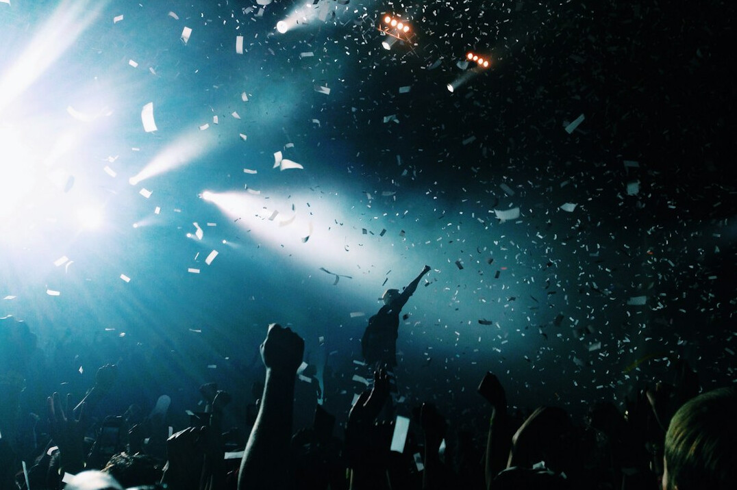 Crowd at a live music concert with stage lights