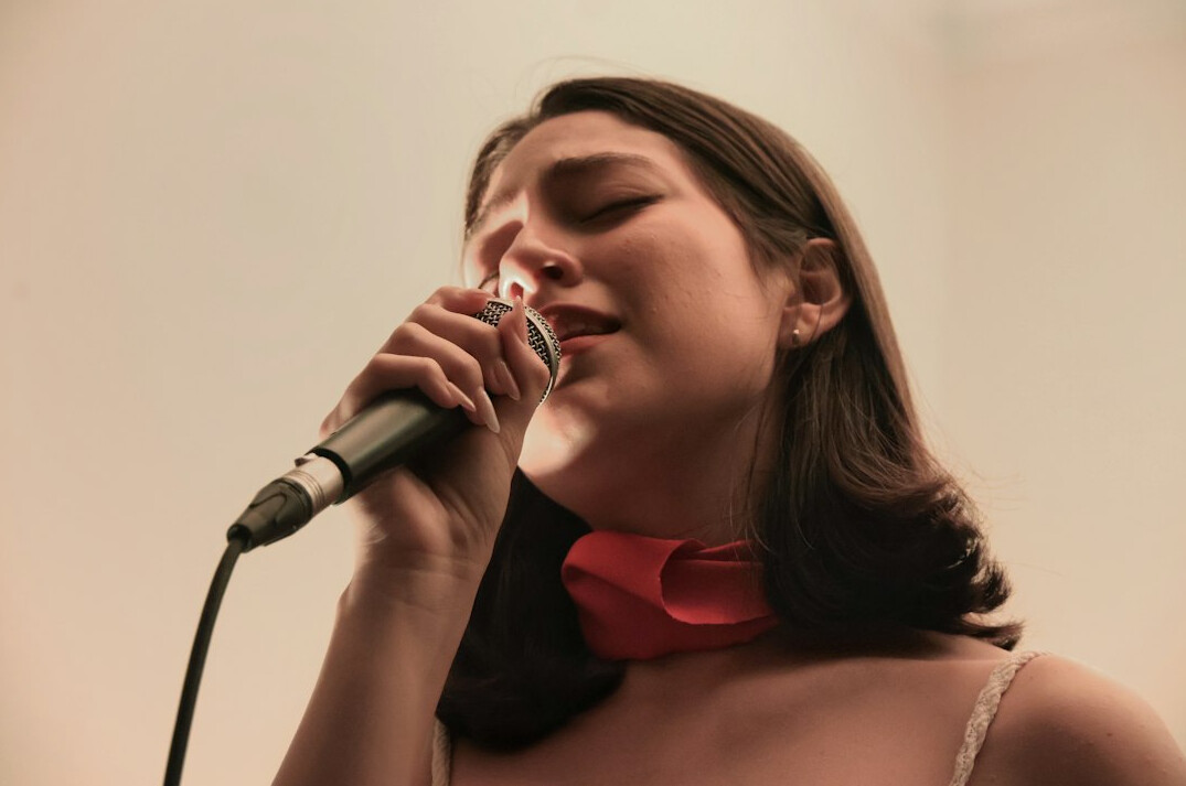 woman singing on stage
